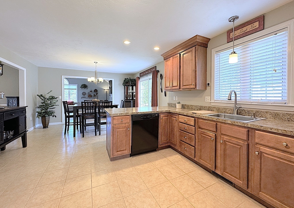 9 Noble Street Dudley, MA 01571 - Photo 13 of 41 a kitchen with lots of counter top space and dining table