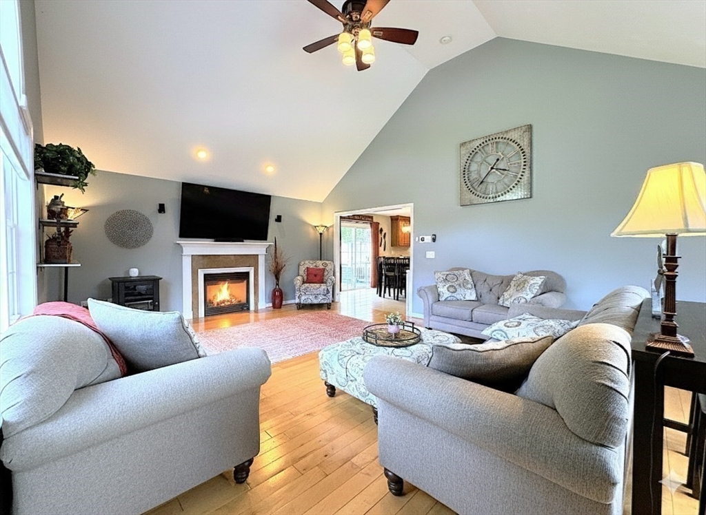9 Noble Street Dudley, MA 01571 - Photo 16 of 41 a living room with furniture a fireplace and a flat screen tv