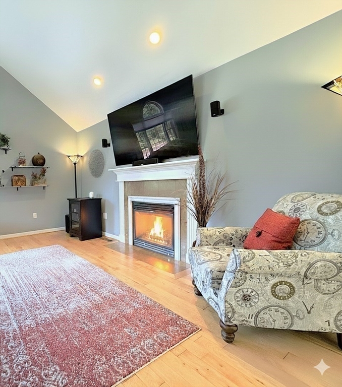 9 Noble Street Dudley, MA 01571 - Photo 18 of 41 a living room with furniture a flat screen tv and a fireplace