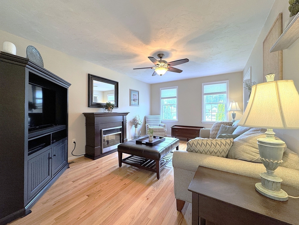 9 Noble Street Dudley, MA 01571 - Photo 21 of 41 a living room with furniture fireplace and a flat screen tv