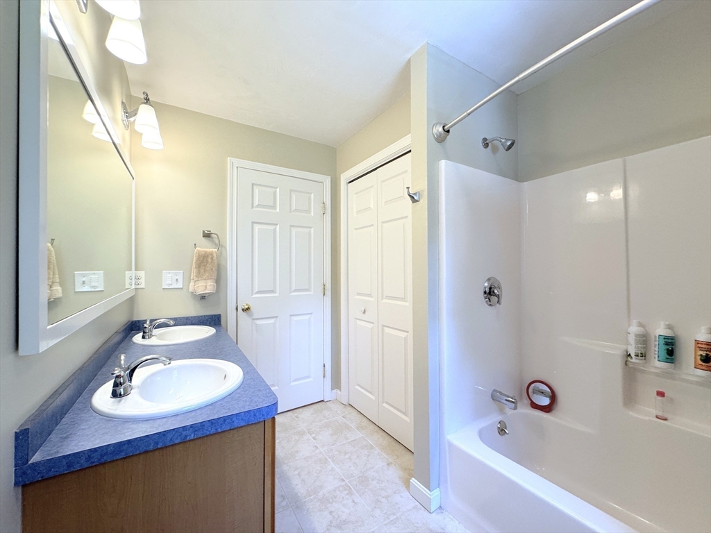 9 Noble Street Dudley, MA 01571 - Photo 28 of 41 a bathroom with a sink double vanity mirror and a bathtub