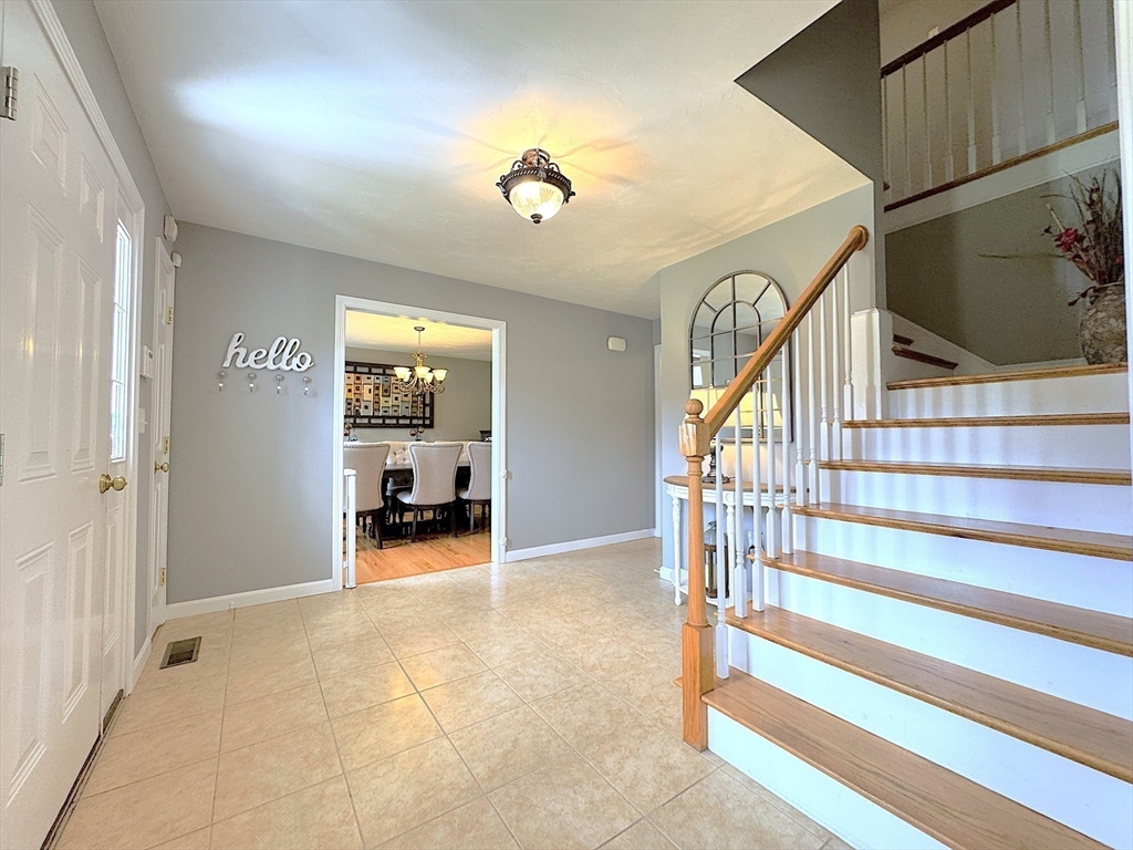 9 Noble Street Dudley, MA 01571 - Photo 5 of 41 a view of a livingroom with wooden floor and stairs