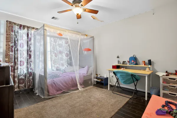 a bedroom with a bed and a chandelier
