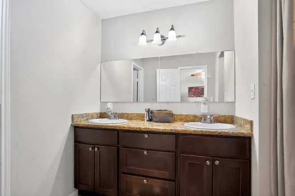 a bathroom with a double vanity sink and a mirror