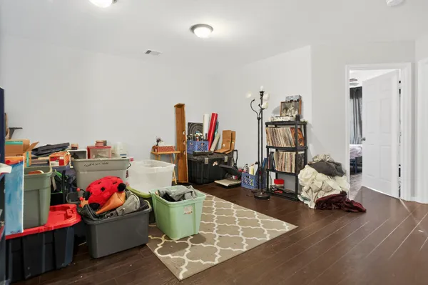 a living room with lots of furniture and a wooden floors