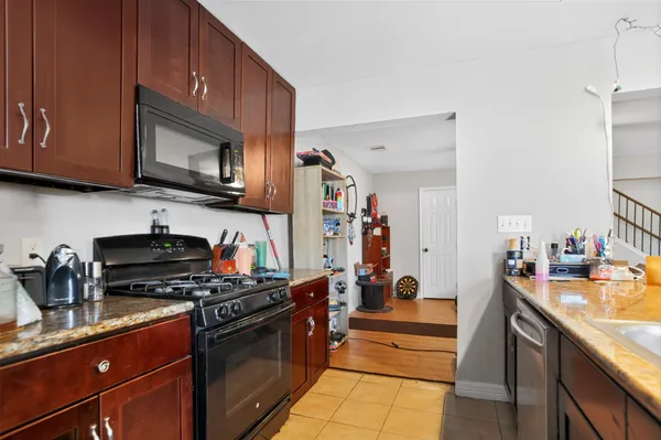 a kitchen with stainless steel appliances granite countertop a stove and a sink