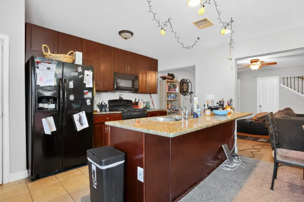 a kitchen with a sink a counter top space and stainless steel appliances