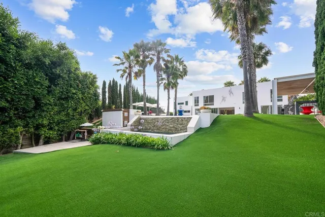 a view of a house with a backyard porch and sitting area