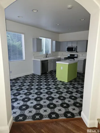 a kitchen with a sink a stove and cabinets
