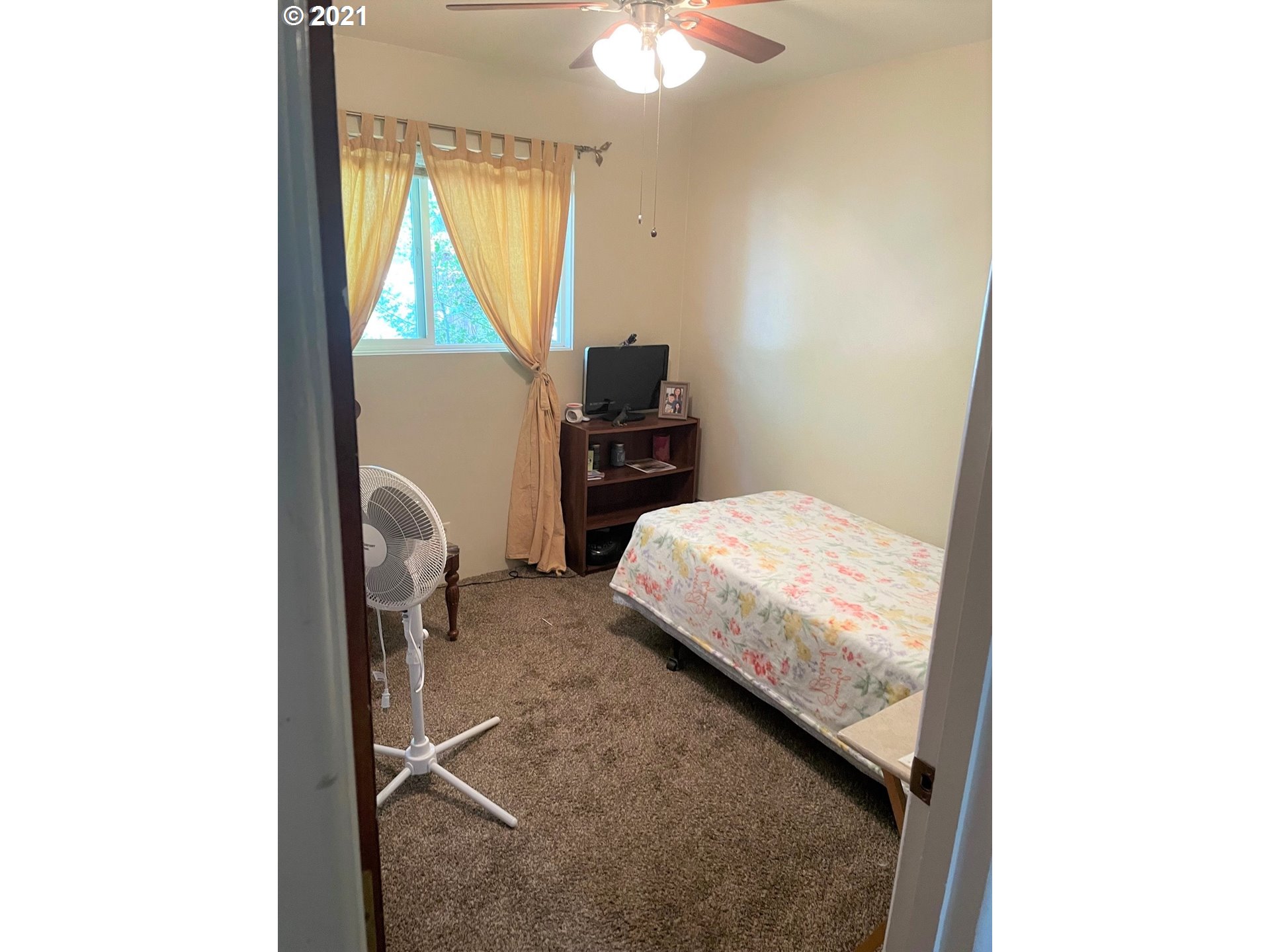 1451 Water Street Springfield, OR 97477 - Photo 11 of 23 a bedroom with a bed and a chandelier