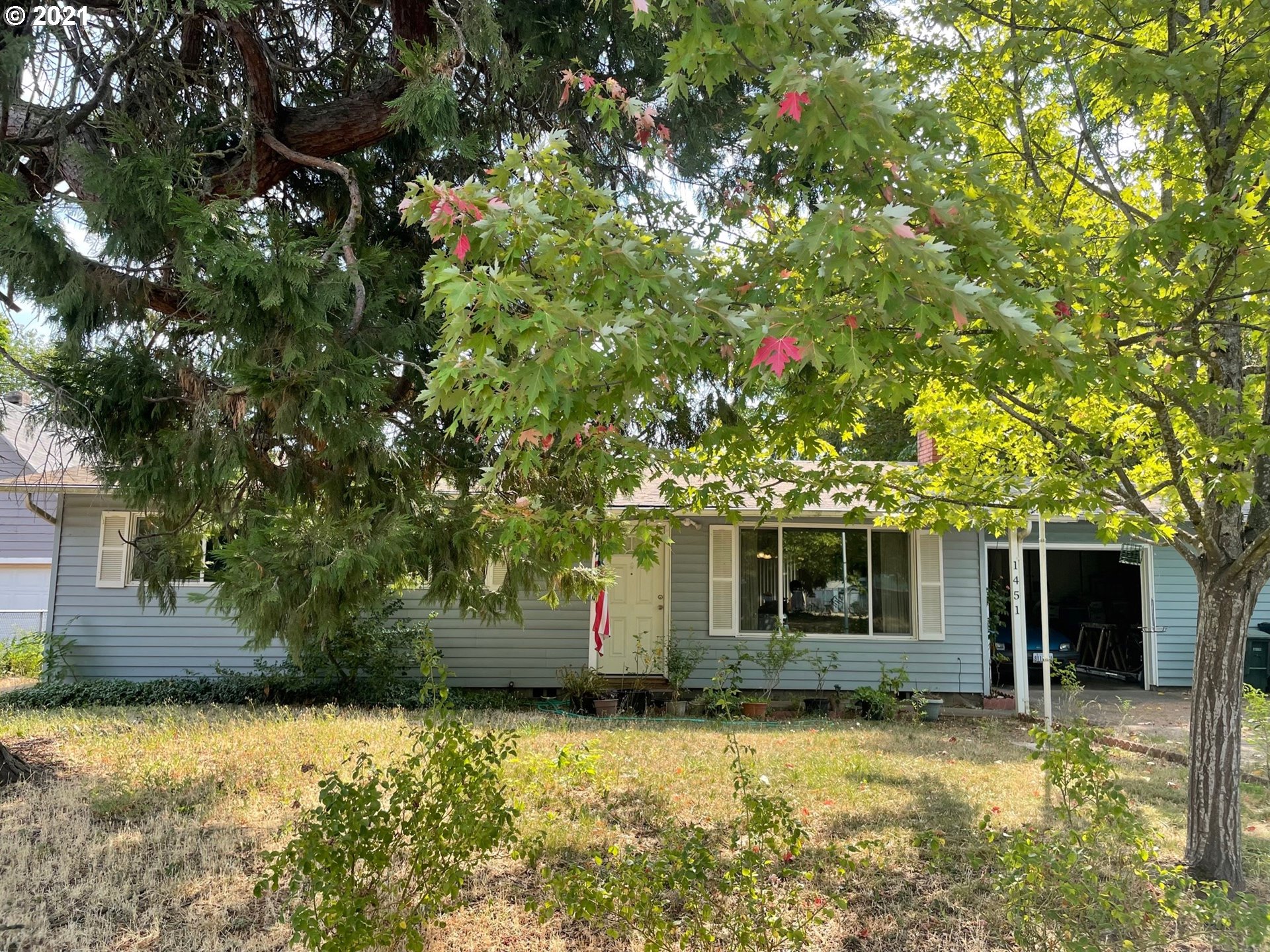 1451 Water Street Springfield, OR 97477 - Photo 2 of 23 a front view of a house with a yard and garage
