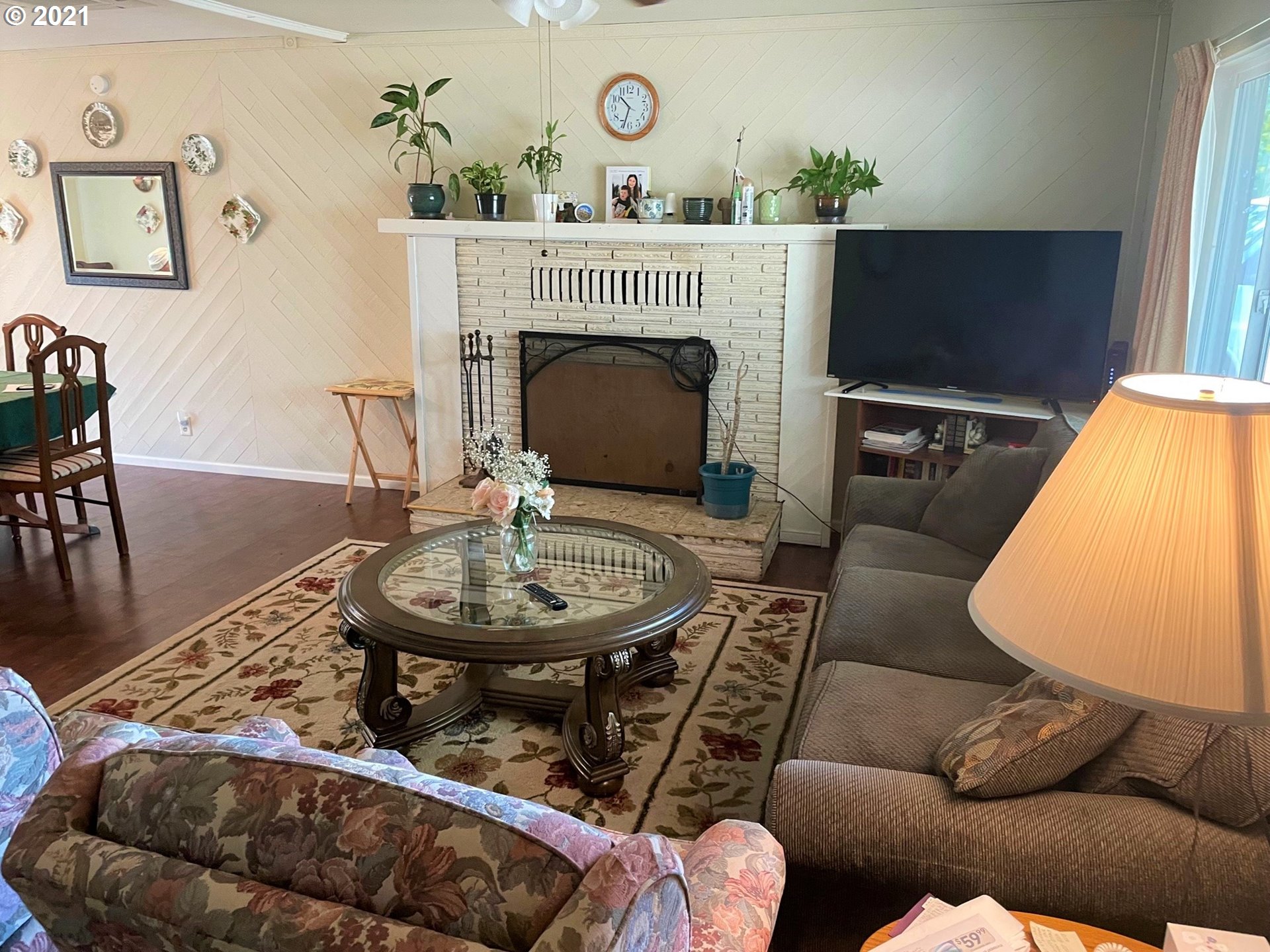 1451 Water Street Springfield, OR 97477 - Photo 4 of 23 a living room with furniture a fireplace and a flat screen tv
