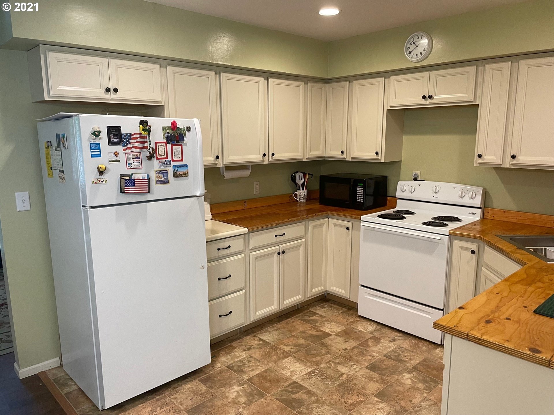 1451 Water Street Springfield, OR 97477 - Photo 6 of 23 a kitchen with white cabinets and white appliances