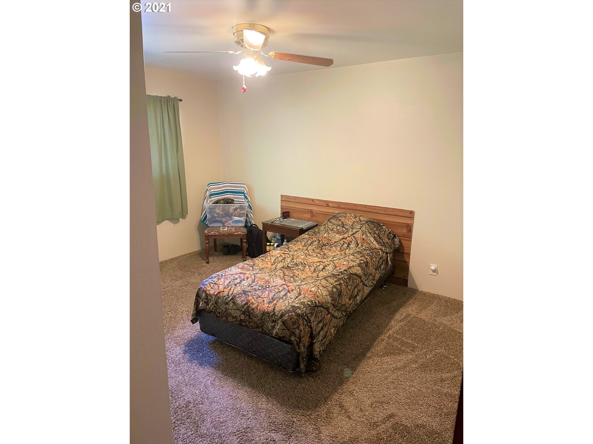 1451 Water Street Springfield, OR 97477 - Photo 9 of 23 a bedroom with a bed and a chandelier