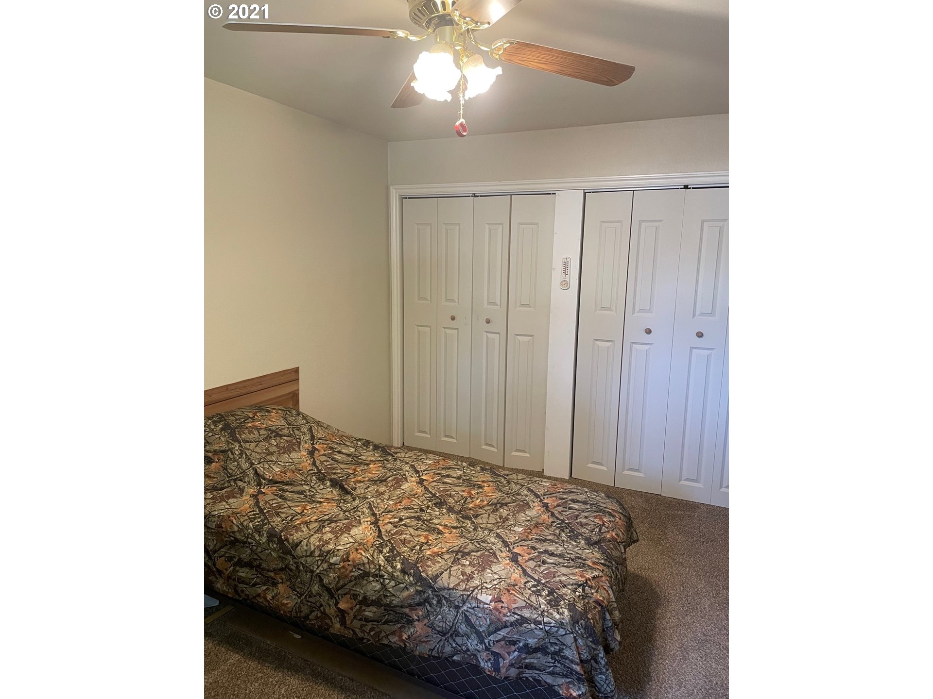 1451 Water Street Springfield, OR 97477 - Photo 10 of 23 a bedroom with a bed and a chandelier