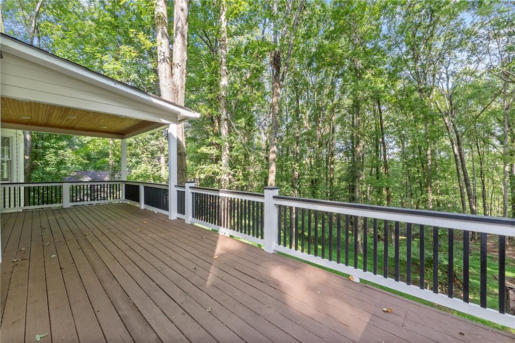 1040 Auburn Road Dacula, GA 30019 - Photo 7 of 42 a view of a wooden deck