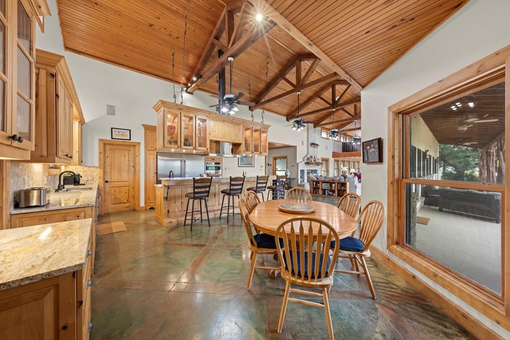 2320 Fiedler Road Harper, TX 78631 - Photo 19 of 78 a dining room with furniture a kitchen view and chandelier