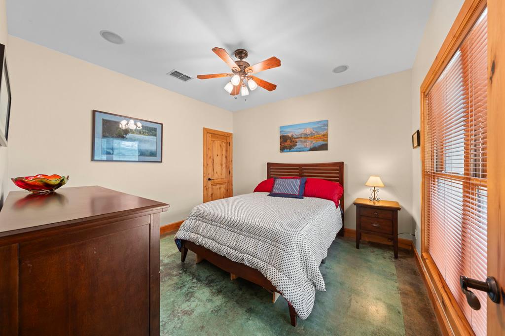 2320 Fiedler Road Harper, TX 78631 - Photo 27 of 78 a bedroom with a bed and a chandelier