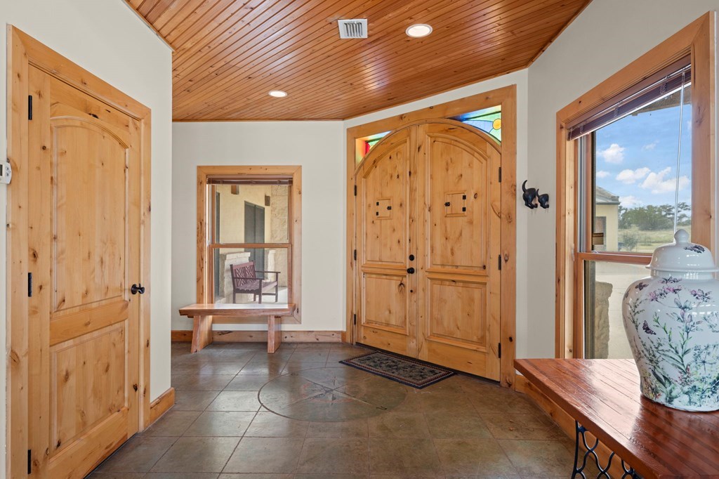 2320 Fiedler Road Harper, TX 78631 - Photo 5 of 78 a view of a hallway with wooden floor and a bathroom