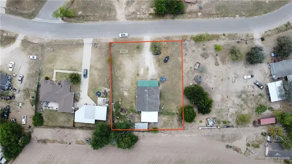 an aerial view of a house with a street