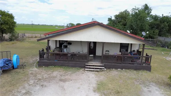 a view of a house with a yard and furniture