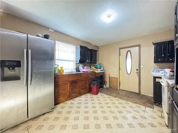 a kitchen with refrigerator cabinets and a sink