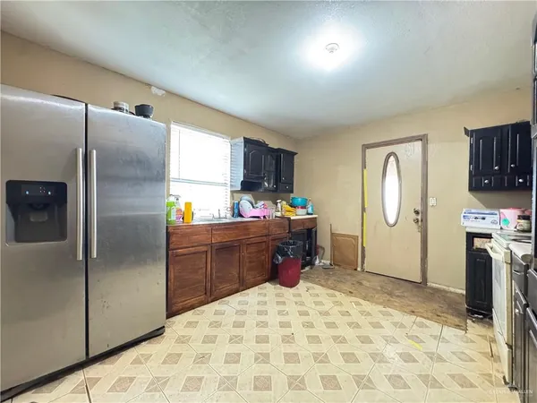 a kitchen with refrigerator cabinets and a sink