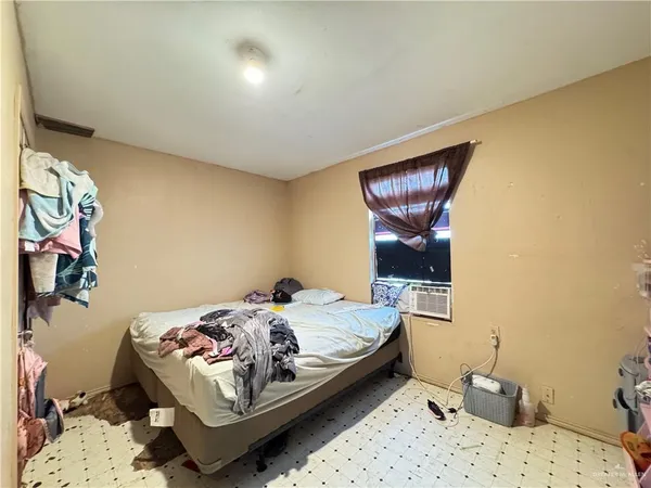 a bedroom with a bed and dresser