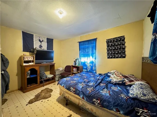 a bedroom with a bed and a flat screen tv