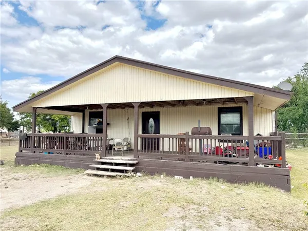 a view of a house with swimming pool and sitting area