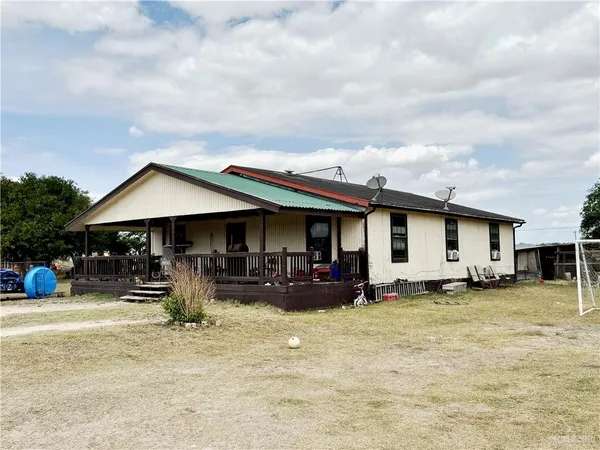 a house view with sitting space and garden
