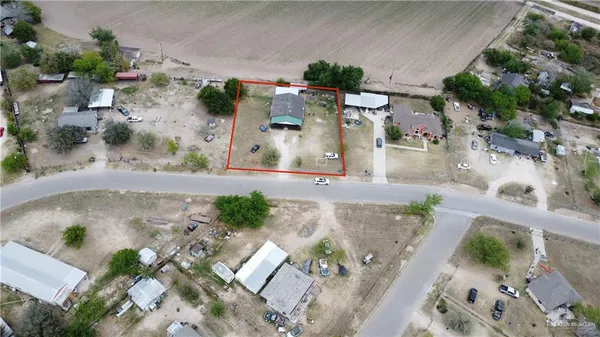 an aerial view of a house with a yard