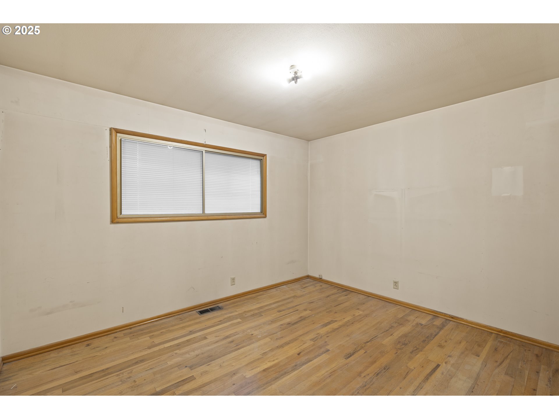 4015 Southwest 185th Avenue Beaverton, OR 97078 - Photo 11 of 47 an empty room with wooden floor and windows