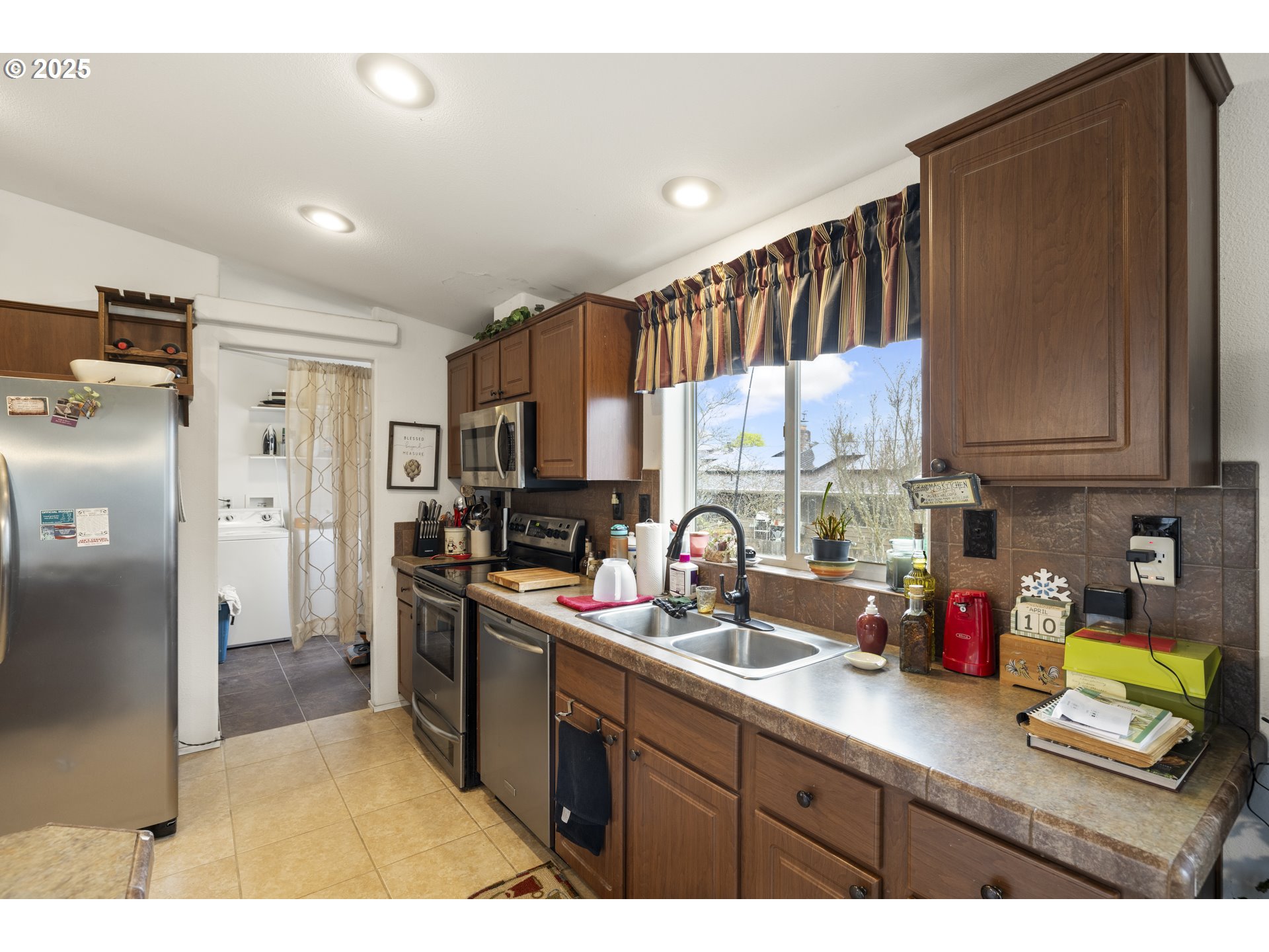 4015 Southwest 185th Avenue Beaverton, OR 97078 - Photo 29 of 47 a kitchen with stainless steel appliances granite countertop a refrigerator sink and stove