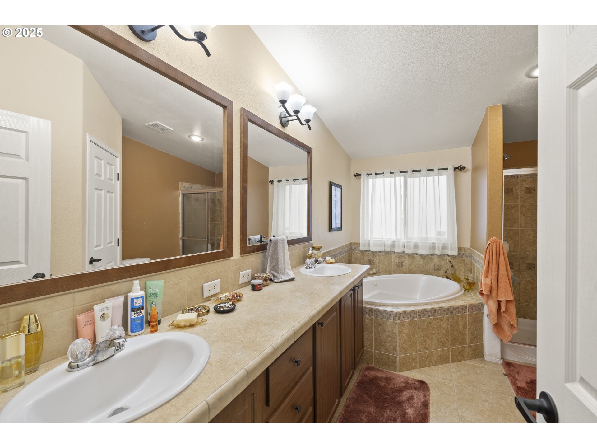 4015 Southwest 185th Avenue Beaverton, OR 97078 - Photo 36 of 47 a bathroom with a granite countertop sink mirror and a bathtub