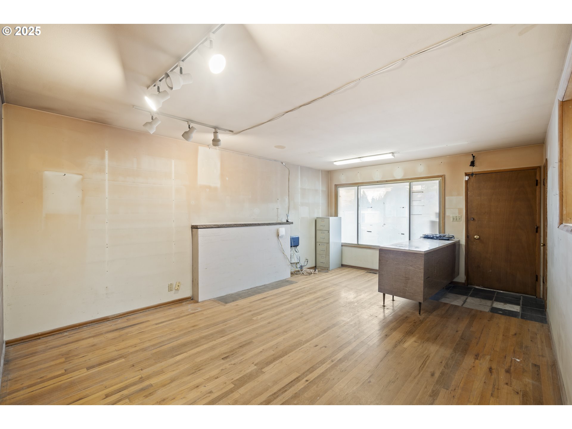 4015 Southwest 185th Avenue Beaverton, OR 97078 - Photo 6 of 47 a view of an empty room with wooden floor and a window
