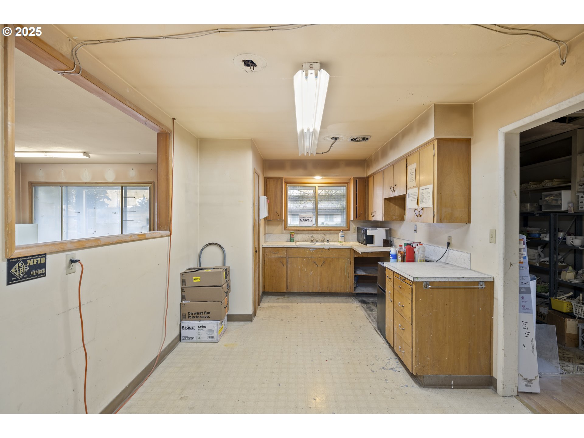 4015 Southwest 185th Avenue Beaverton, OR 97078 - Photo 9 of 47 a living room with stainless steel appliances kitchen island a table chairs in it and a window