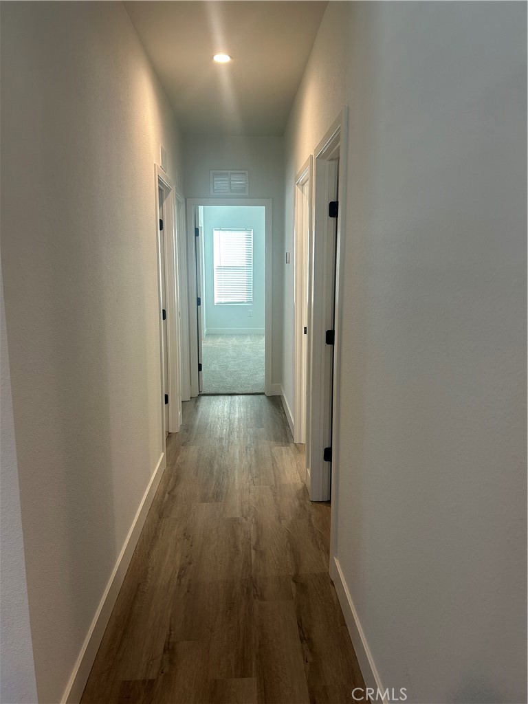 15601 South B Street, Unit 12 Tustin, CA 92780 - Photo 14 of 22 a view of a hallway with wooden floor
