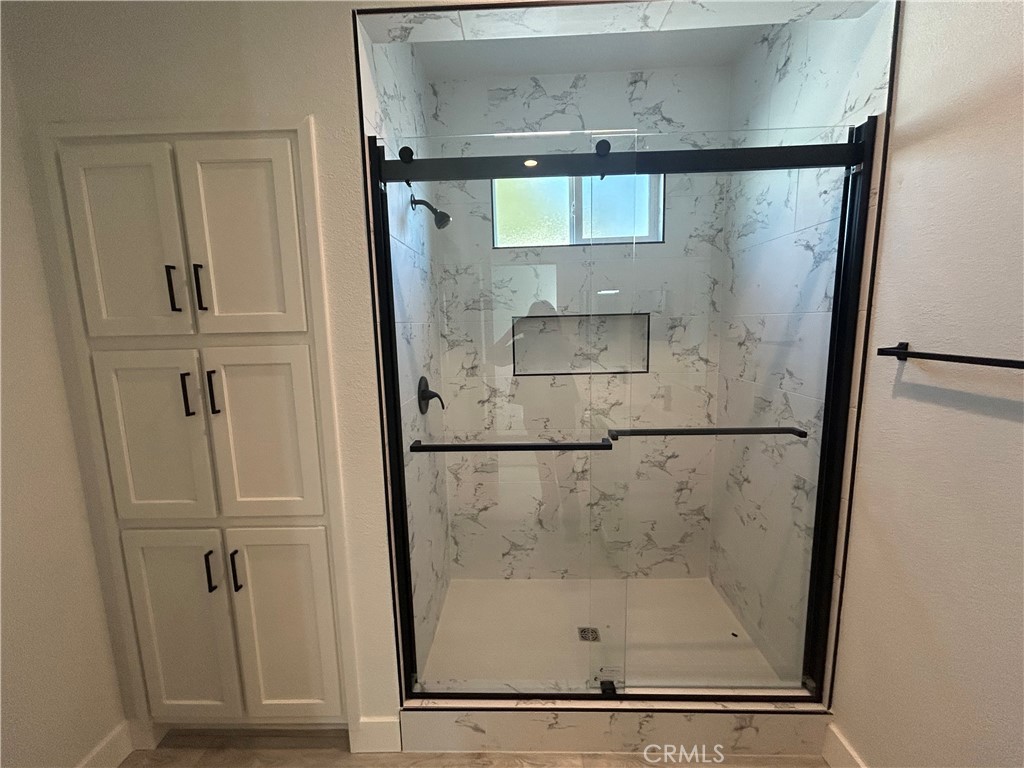 15601 South B Street, Unit 12 Tustin, CA 92780 - Photo 18 of 22 a bathroom with a glass shower door