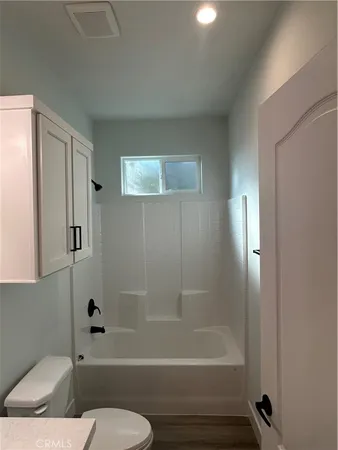 a bathroom with a toilet and a bathtub