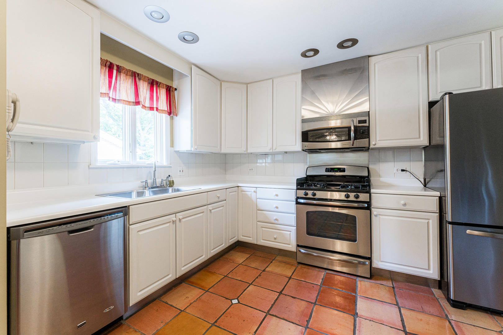 413 Oak Street Elmhurst, IL 60126 - Photo 12 of 38 a kitchen with a sink cabinets stainless steel appliances and a window