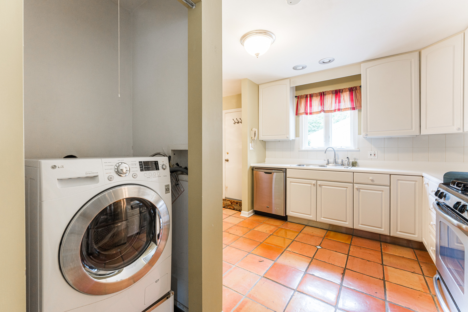 413 Oak Street Elmhurst, IL 60126 - Photo 10 of 38 a kitchen with a sink a stove cabinets and a window