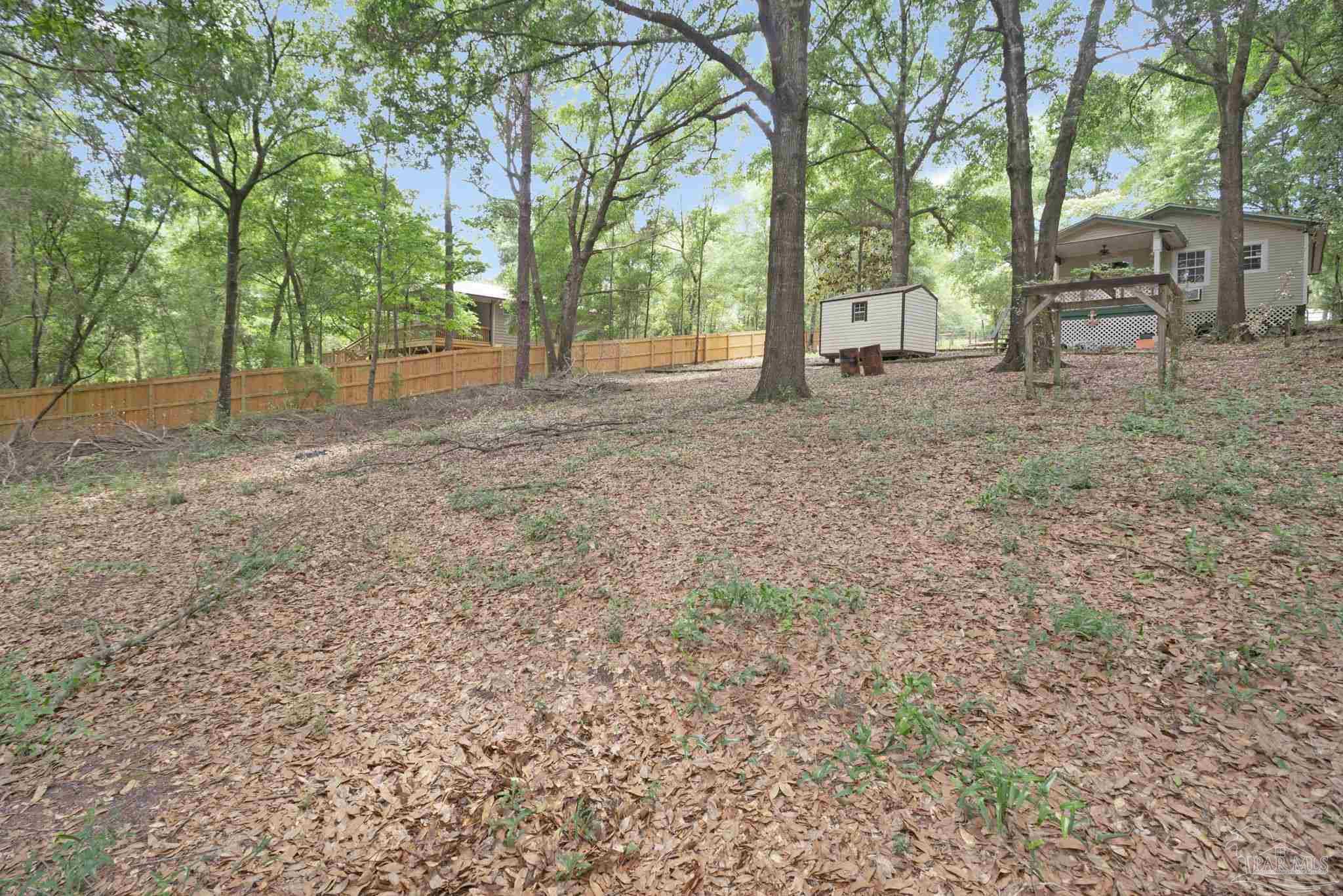 10290 West Lake Road Milton, FL 32583 - Photo 36 of 53 a view of a yard with tree s