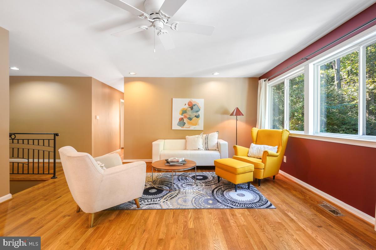 10411 Adel Road Oakton, VA 22124 - Photo 8 of 27 Cozy living room has large windows framing trees.