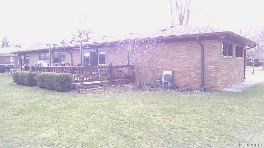 REAR VIEW OF HOUSE. NOTE LARGE WOOD DECK AND DOORWALL TO FAMILY ROOM.