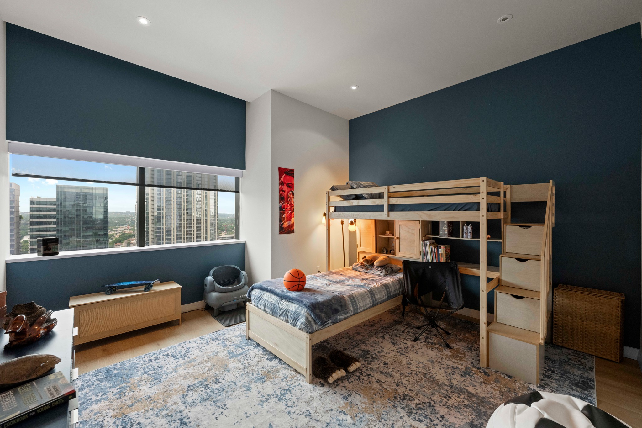 210 Lavaca Street, Unit 2706 Austin, TX 78701 - Photo 27 of 32 Expansive window offering urban scenery, complemented by a contemporary blue accent wall
