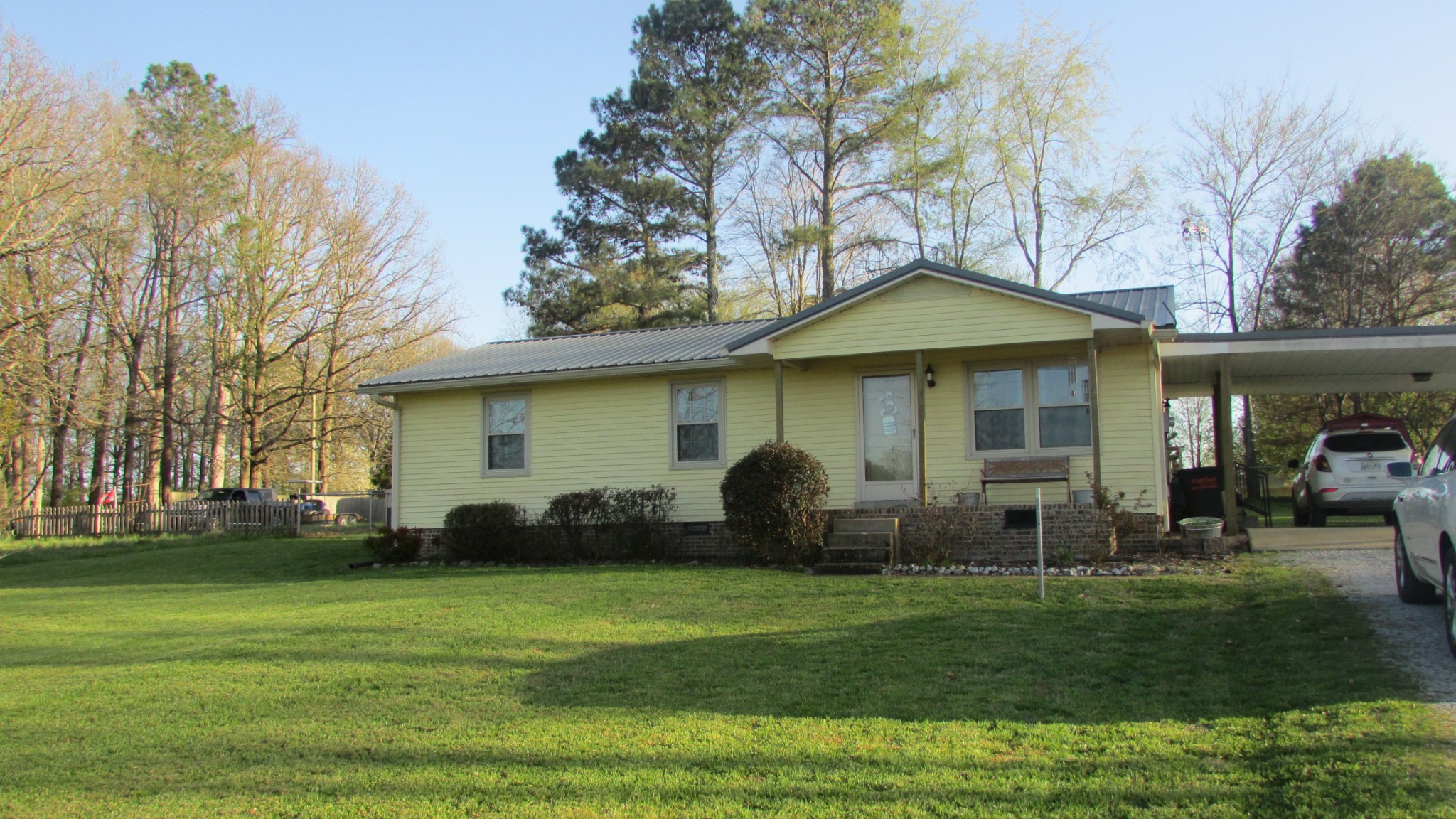 3455 Gimlet Road Lawrenceburg, TN 38464 - Photo 23 of 28 a front view of a house with a garden and trees