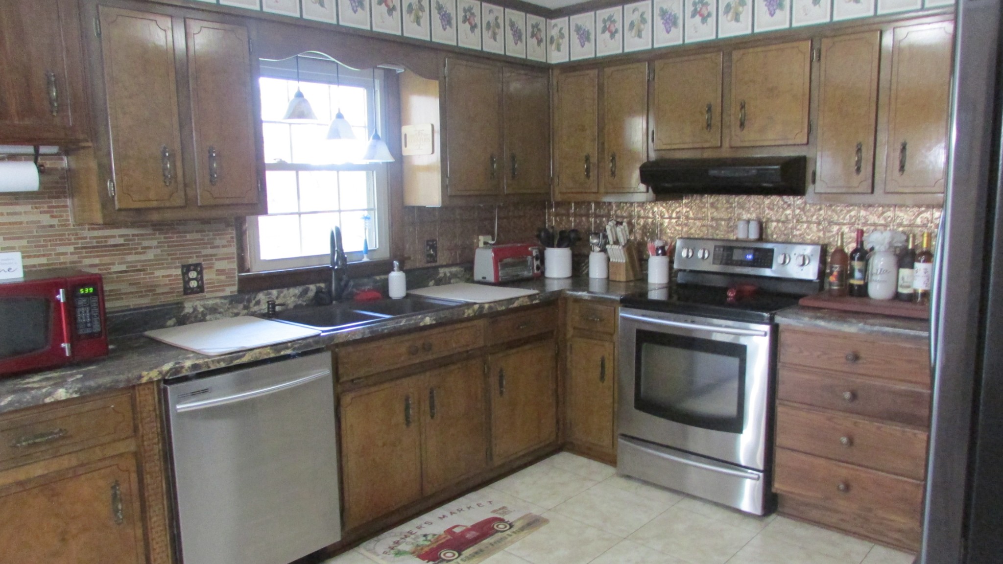 3455 Gimlet Road Lawrenceburg, TN 38464 - Photo 8 of 28 a kitchen with stainless steel appliances granite countertop a sink stove and microwave