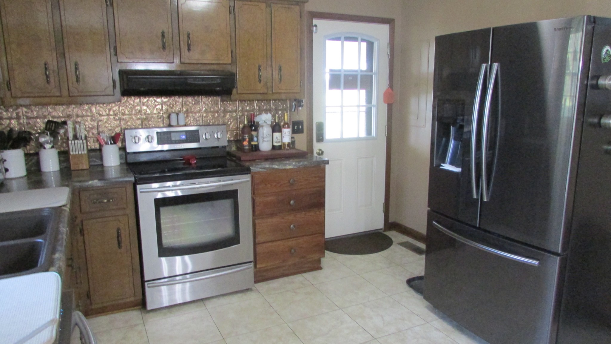 3455 Gimlet Road Lawrenceburg, TN 38464 - Photo 9 of 28 a kitchen with stainless steel appliances granite countertop a refrigerator stove and sink