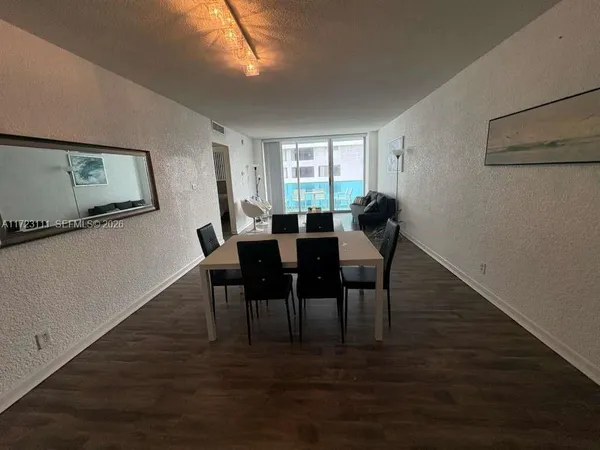 a view of a livingroom with furniture window and wooden floor